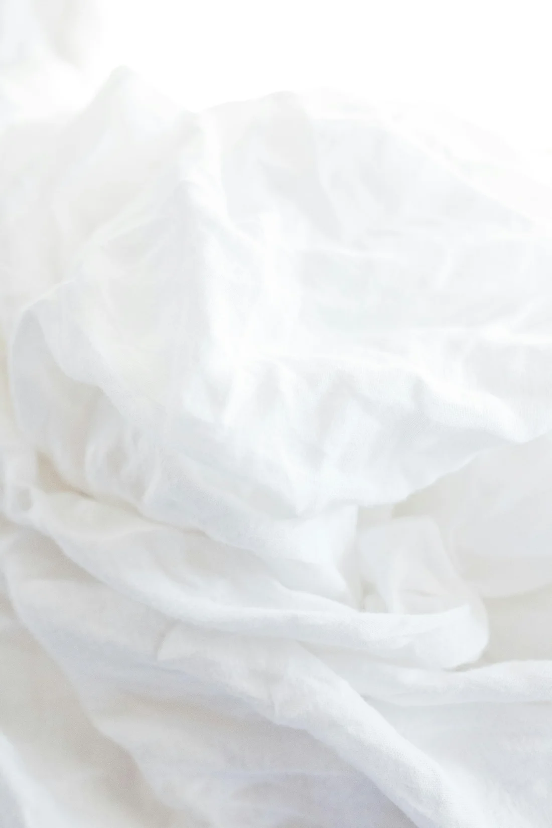 Natural folds and texture in white bed linen